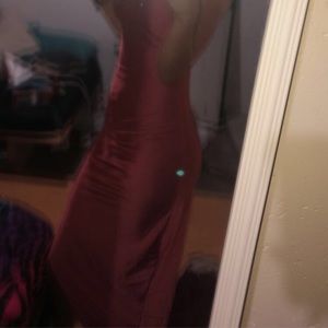 long dress with a small slit in the side. it is pink
